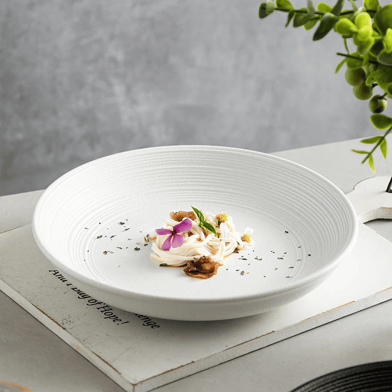 Modern 25cm ceramic plate with a stylish spiral pattern, microwave safe and great for casual meals and snacks.