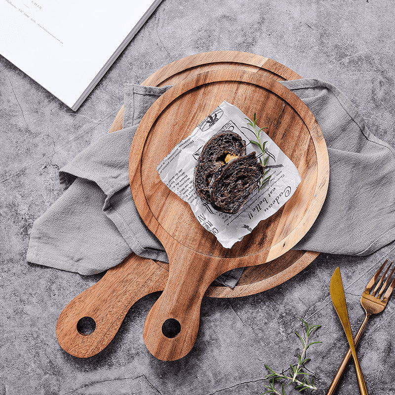Elegant Rustik wooden serving board with slate surface and handle for serving cheese and charcuterie.