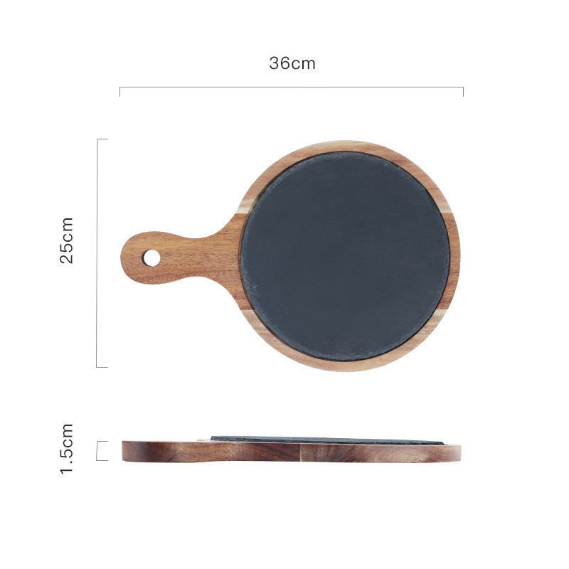 Product shot of Rustik wooden serving board with slate surface and handle in a rustic kitchen setting.