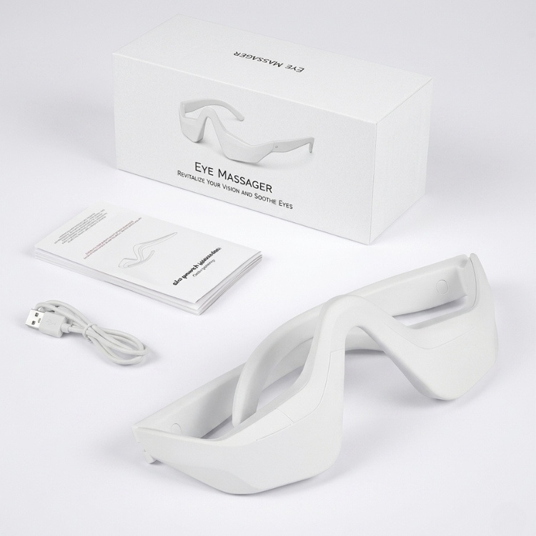 InfraRelief™ Ögonmassager produktpaket – vit enhet, USB-laddningskabel, användarmanual och förpackning mot vit bakgrund